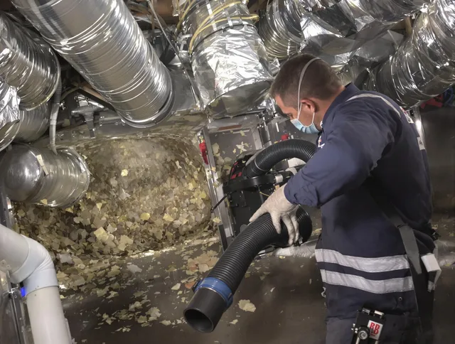 Winchester Air Duct Cleaning specialist operating negative pressure cleaning equipment for thorough duct maintenance in Winchester