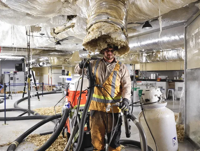Professional vacuum insulation removal by Winchester Air Duct Cleaning expert in Winchester